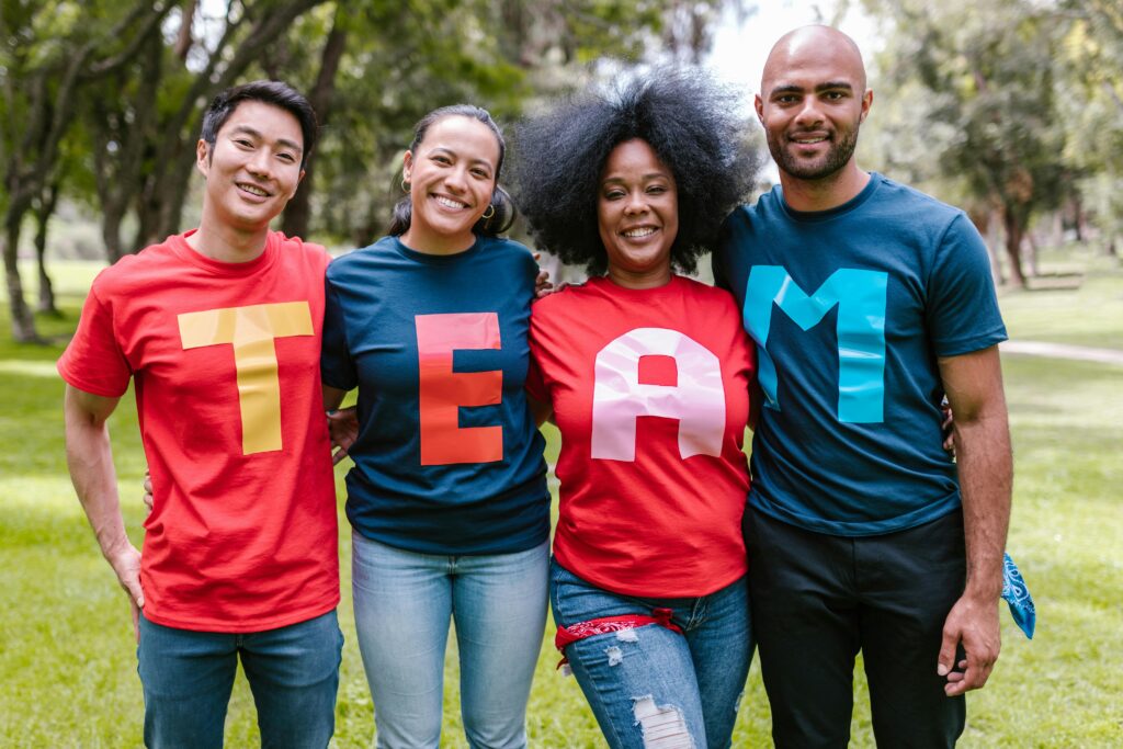 People wearing shirts that together read TEAM